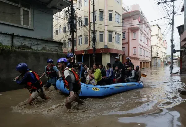 Residents being evacuated by rescue boat in Nepal